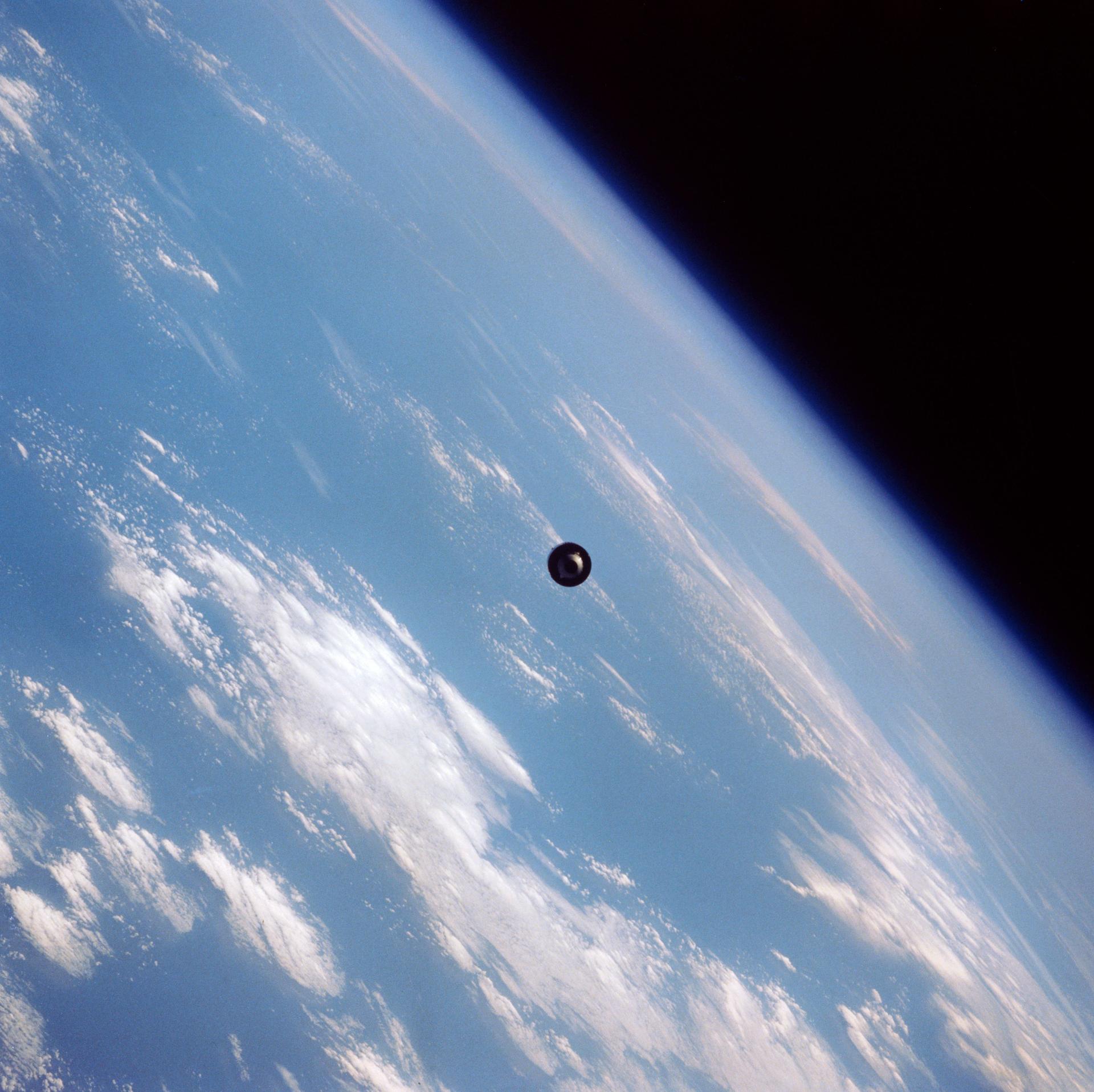 Communications satellite in Earth orbit, solar panels extended against the blackness of space